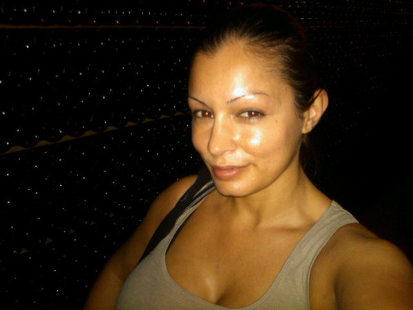In front of a wall of bottles...