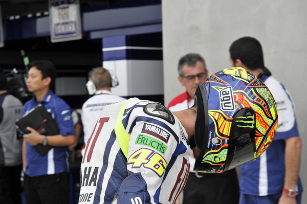 Rossi has a picture of Tomizawa painted on his crash helmet...