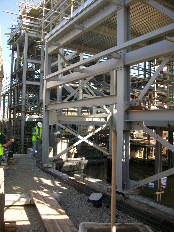 The steel frame is complete, roof sheeting is now in place, and the floors are being laid. Screens 1 &amp; 2 walls well under way. 3/5