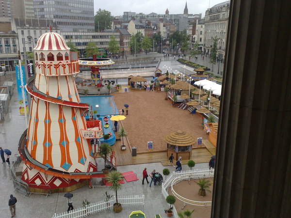 Next to no-one on the sand in the rain.