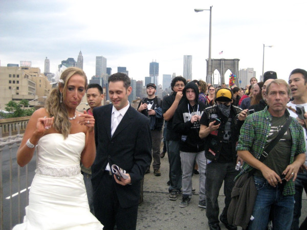 Photo: A wedding couple reacts to #OccupyWallStreet protestors crossing the Brooklyn Bridge.