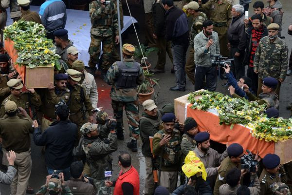 #Indian #police officers carry the coffins of fallen comrades, who were killed March 13 in an ambush, following a ceremony in Srinagar on March 14, 2013. 