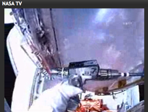 Astronaut Mike Massimino uses an old-style Star Trek phaser on a stubborn bolt on Hubble.