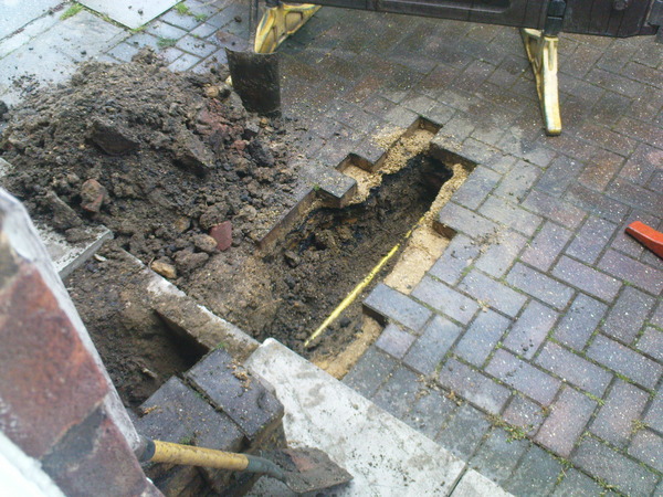 Neighbours garden, slab, dirt. My garden, bricks, two layers of tarmac.