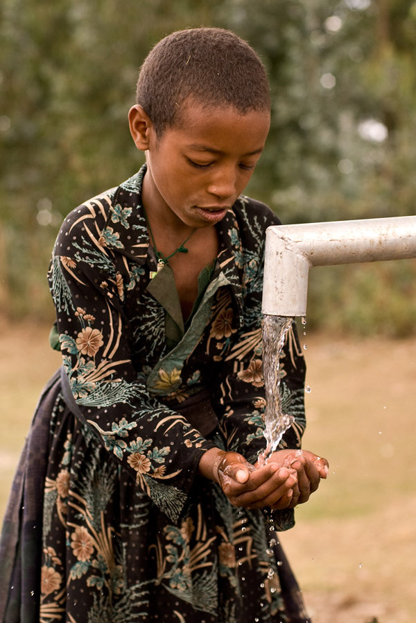 A child drinks from a completed @charitywater well in the village of Shinet, Ethiopia. Build your well at www.charitywater.org