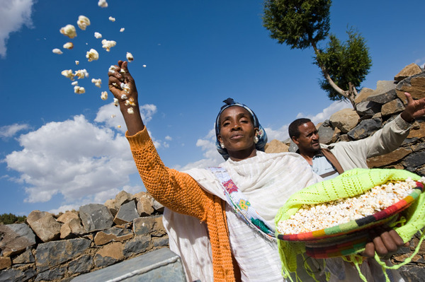 A woman in Tigray, Ethiopia greets us with popcorn, celebrating her new well - www.charitywater.org